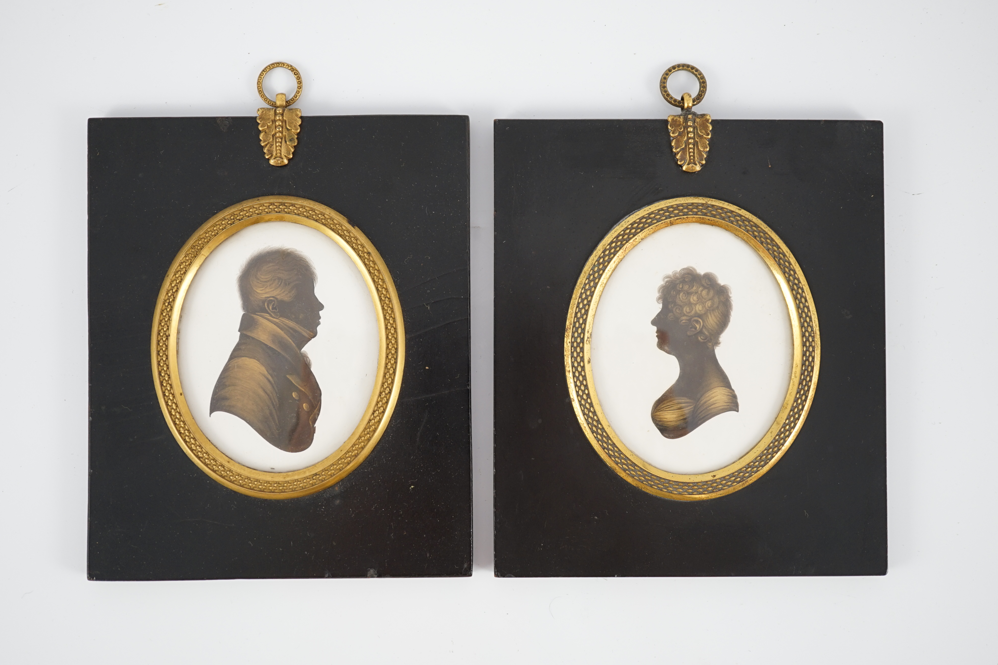 John Miers (1756-1821) and John Field (1772-1848), Silhouettes of a lady and gentleman, painted and bronzed plaster (a pair), 8 x 6.5cm.